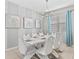Modern dining room with white table, chairs, and stylish light fixture at 1808 Sandy Park Trl, Kissimmee, FL 34747