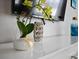 White dresser with decorative items and a TV at 1808 Sandy Park Trl, Kissimmee, FL 34747