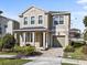 Two-story house with a neutral color scheme, a large garage, and a well-manicured lawn at 1808 Sandy Park Trl, Kissimmee, FL 34747