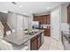Modern kitchen with wood cabinets and granite countertops at 1808 Sandy Park Trl, Kissimmee, FL 34747