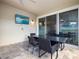 Outdoor patio with table, chairs, and TV at 1808 Sandy Park Trl, Kissimmee, FL 34747
