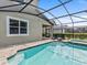 Enclosed pool and spa with lounge chairs at 1808 Sandy Park Trl, Kissimmee, FL 34747