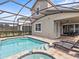 Enclosed pool and spa with lounge chairs at 1808 Sandy Park Trl, Kissimmee, FL 34747