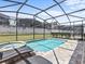 Enclosed pool and spa with lounge chairs at 1808 Sandy Park Trl, Kissimmee, FL 34747