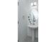 Small bathroom with pedestal sink and oval mirror at 2229 Shadowland Loop, Winter Park, FL 32792
