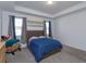 Bright bedroom with double bed, gray carpet, and two windows at 2229 Shadowland Loop, Winter Park, FL 32792