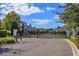 Gated community entrance with landscaped medians and modern townhouses at 2229 Shadowland Loop, Winter Park, FL 32792