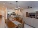 Bright dining room with wood table and modern chandelier at 2229 Shadowland Loop, Winter Park, FL 32792