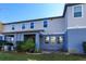 Townhome building exterior, showcasing a patio and landscaping at 2229 Shadowland Loop, Winter Park, FL 32792