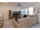 Spacious living room featuring a large sectional sofa and ceiling fan at 2229 Shadowland Loop, Winter Park, FL 32792