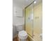 Bathroom featuring a commode, cabinet, and standing shower with yellow tile at 2459 Hunterfield Rd, Maitland, FL 32751
