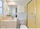 Bathroom featuring a vanity, commode, and a standing shower with yellow tile at 2459 Hunterfield Rd, Maitland, FL 32751