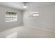 Bright bedroom with neutral carpet, ceiling fan, and natural light from two windows at 2459 Hunterfield Rd, Maitland, FL 32751