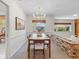 Inviting dining room featuring a modern chandelier and a unique brick room divider at 2459 Hunterfield Rd, Maitland, FL 32751