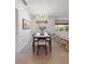 Elegant dining room featuring a modern chandelier, stylish decor, and a unique brick accent wall at 2459 Hunterfield Rd, Maitland, FL 32751