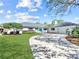 Well-maintained single-story home boasting a circular driveway, lush lawn, and a detached garage at 2459 Hunterfield Rd, Maitland, FL 32751