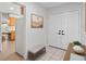 Bright foyer area with tiled flooring, a bench, and access to the kitchen and main living spaces at 2459 Hunterfield Rd, Maitland, FL 32751