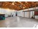 Open garage with exposed wood beams and high ceiling with laundry and storage at 2459 Hunterfield Rd, Maitland, FL 32751