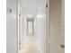 Bright hallway with neutral walls, and doors leading to various rooms at 2459 Hunterfield Rd, Maitland, FL 32751