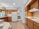 Spacious kitchen area featuring ample cabinet space, white appliances, and seamless access to the foyer at 2459 Hunterfield Rd, Maitland, FL 32751