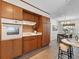 Cozy kitchen with built-in oven, cooktop, and direct access to the dining area, ideal for Gathering meals at 2459 Hunterfield Rd, Maitland, FL 32751