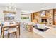 Bright and airy living room featuring a fireplace, built-in shelves, and unique brick room divider at 2459 Hunterfield Rd, Maitland, FL 32751