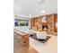 Cozy living room featuring a brick fireplace with built-in shelves and neutral furnishings at 2459 Hunterfield Rd, Maitland, FL 32751