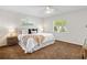 Well-lit main bedroom featuring a comfortable bed, side tables, and natural light from the windows at 2459 Hunterfield Rd, Maitland, FL 32751