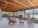 Enclosed patio featuring wood furnishings and plenty of seating, perfect for relaxing outdoors at 2459 Hunterfield Rd, Maitland, FL 32751