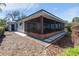 Side view of the screened-in patio and exterior of the home, landscaping at 2459 Hunterfield Rd, Maitland, FL 32751