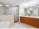 Modern bathroom features a double vanity, soaking tub, and glass-enclosed shower, perfect for relaxation at 260 S Osceola Ave # 1001, Orlando, FL 32801