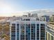 Stunning exterior view of a high-rise building with rooftop amenity deck and pool with skyline view at 260 S Osceola Ave # 1001, Orlando, FL 32801