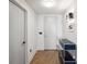 Modern hallway with light-colored walls, hardwood floors, and a blue storage cabinet at 260 S Osceola Ave # 1001, Orlando, FL 32801