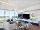 A modern living room features a large television, stylish furniture, and expansive windows with scenic views at 260 S Osceola Ave # 1001, Orlando, FL 32801