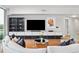 Spacious living room featuring a large TV and modern shelving at 260 S Osceola Ave # 1001, Orlando, FL 32801