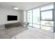 Bright main bedroom features floor-to-ceiling windows offering city views and a modern entertainment center at 260 S Osceola Ave # 1001, Orlando, FL 32801