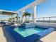 Beautiful rooftop pool and spa area with lounge seating and bright blue mosaic tiles and a view at 260 S Osceola Ave # 1001, Orlando, FL 32801