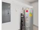 Functional utility room with water heater, electrical panel and storage shelf at 260 S Osceola Ave # 1001, Orlando, FL 32801