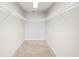 Empty walk-in closet offers a blank canvas to create your dream storage solution with shelving and hanging rods at 260 S Osceola Ave # 1001, Orlando, FL 32801