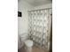 Bathroom with shower/tub, toilet, and patterned shower curtain at 2723 Andros Ln, Kissimmee, FL 34747