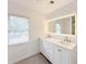 Modern bathroom with double vanity and large mirror at 2827 Sanctuary Ln, Winter Garden, FL 34787