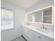 Modern bathroom with double vanity and large mirror at 2827 Sanctuary Ln, Winter Garden, FL 34787
