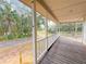 Wooden front porch overlooking a tree-lined yard at 2827 Sanctuary Ln, Winter Garden, FL 34787