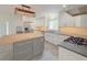 Modern kitchen features a butcher block island and stainless steel appliances at 2827 Sanctuary Ln, Winter Garden, FL 34787