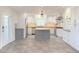 Modern kitchen features gray and white cabinets, an island, and tile flooring at 2827 Sanctuary Ln, Winter Garden, FL 34787