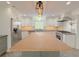 Modern kitchen features a butcher block island and stainless steel appliances at 2827 Sanctuary Ln, Winter Garden, FL 34787