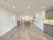 Modern kitchen features gray and white cabinets, an island, and tile flooring at 2827 Sanctuary Ln, Winter Garden, FL 34787