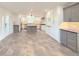 Modern kitchen features gray and white cabinets, an island, and tile flooring at 2827 Sanctuary Ln, Winter Garden, FL 34787
