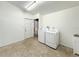 Laundry room with washer, dryer, and extra storage at 2827 Sanctuary Ln, Winter Garden, FL 34787