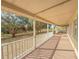 Spacious front porch with white railing overlooks a lush green yard at 2827 Sanctuary Ln, Winter Garden, FL 34787